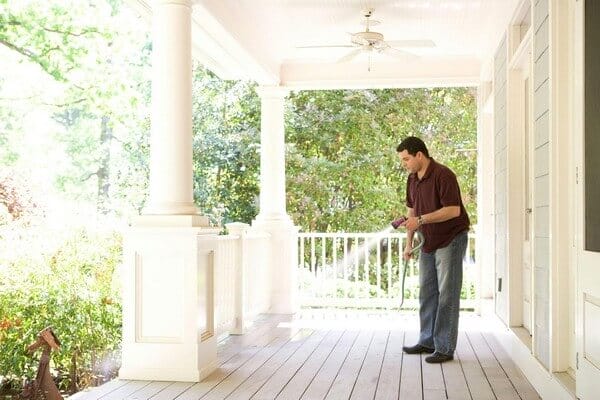 man spraying anti pest spray
